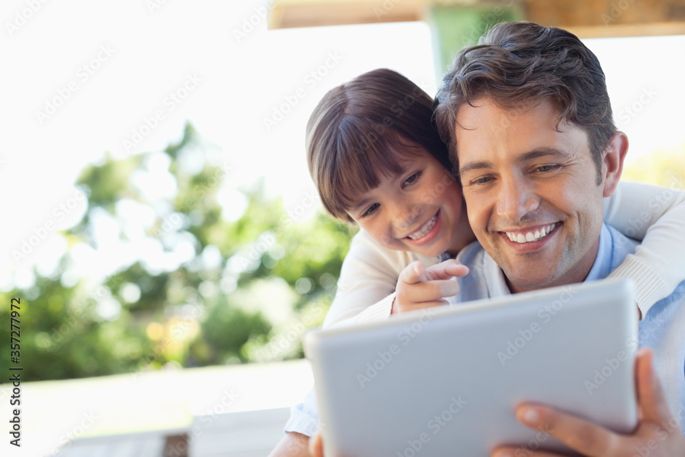 Father and daughter using tablet computer together Father and daughter using tablet computer together