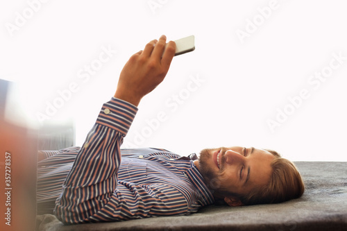 Man using cell phone on bench
