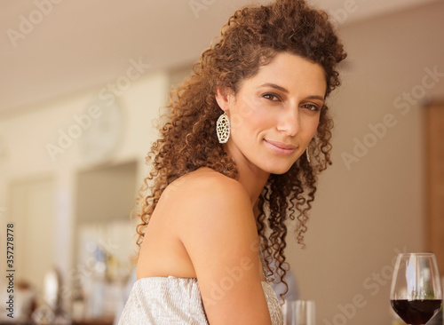 Smiling woman having glass of wine