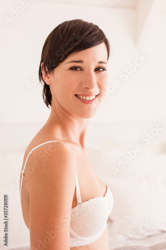 Portrait of smiling woman in bra