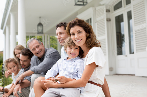 Tableau sur toile Family relaxing on porch together