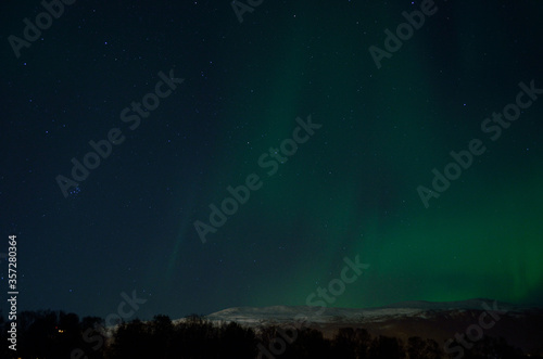 majestic strong aurora borealis on autumn star filled night sky © Arcticphotoworks