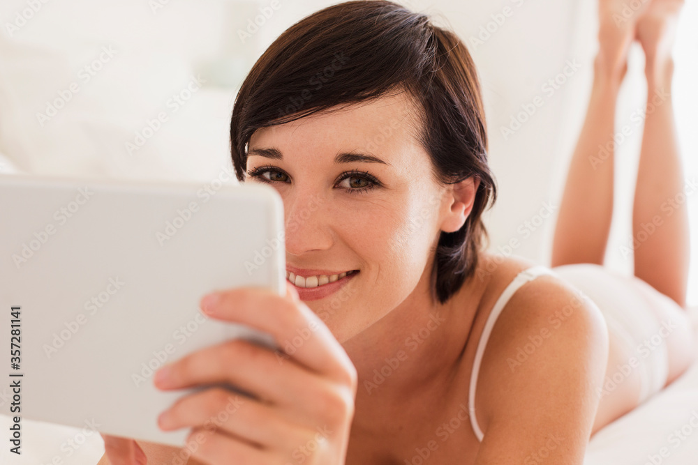 Close up portrait of smiling woman using digital tablet Close up portrait of smiling woman using digital tablet
