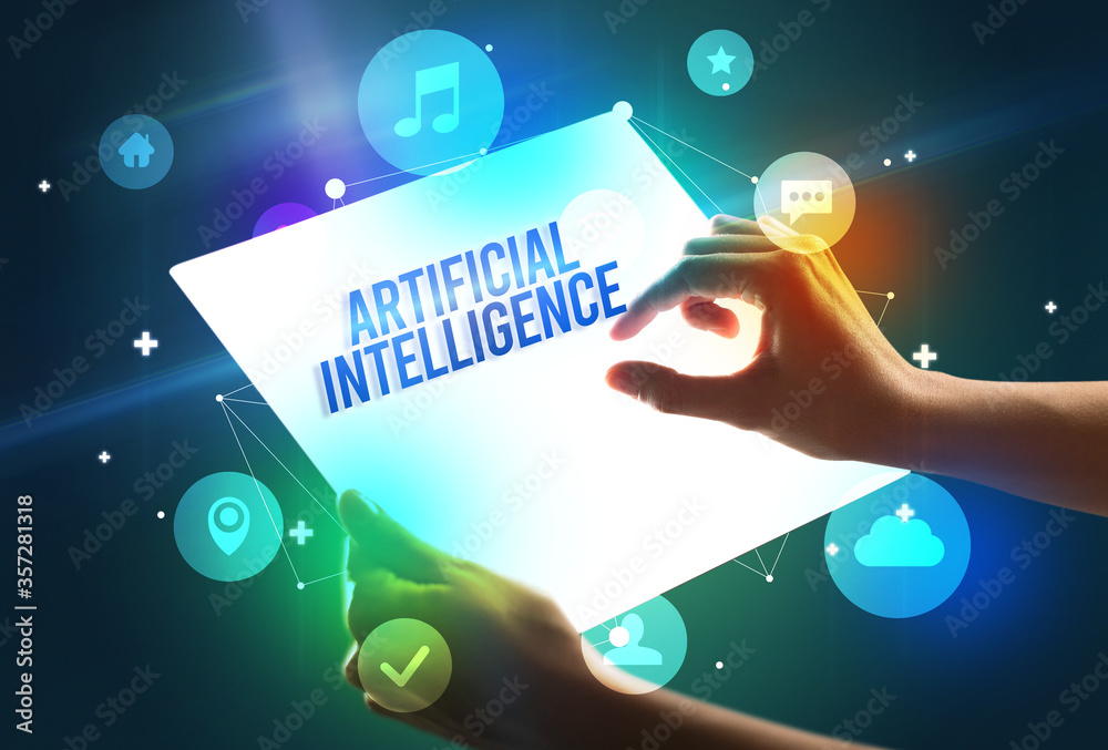 Holding futuristic tablet with ARTIFICIAL INTELLIGENCE inscription, new technology concept Holding futuristic tablet with ARTIFICIAL INTELLIGENCE inscription, new technology concept