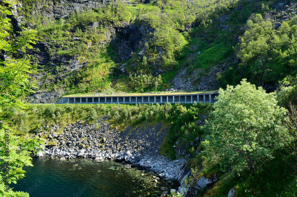 semi open tunnel protecting from falling rocks with seashore underneath semi open tunnel protecting from falling rocks with seashore underneath