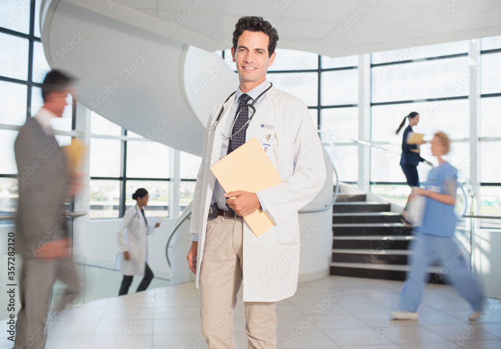 Doctor carrying folders in hospital Doctor carrying folders in hospital