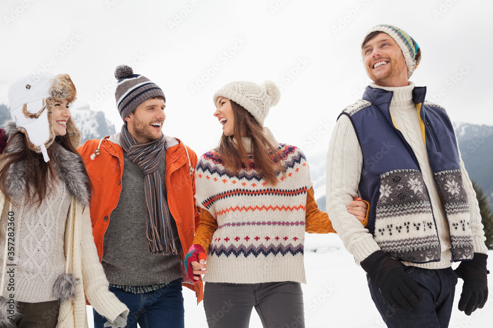 Happy friends walking in snow Happy friends walking in snow