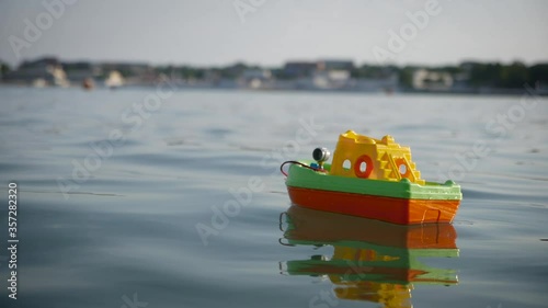 A toy boat on a wave of the sea