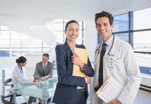 Portrait of smiling businesswoman and doctor in meeting