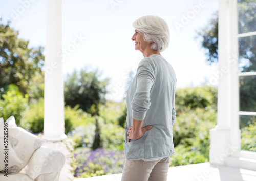 Senior woman standing on patio © Paul Bradbury/KOTO