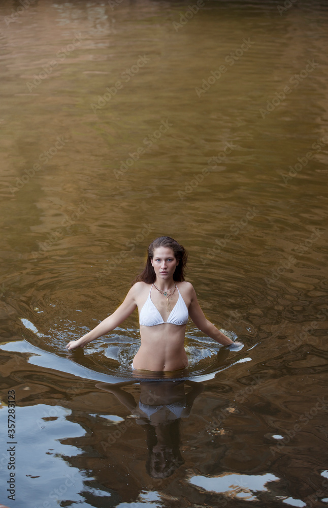 Woman wading in river Woman wading in river