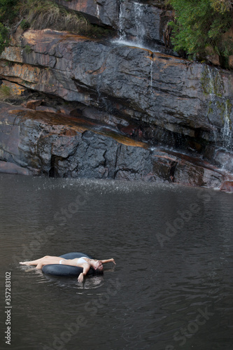 Woman floating in inner tube on river