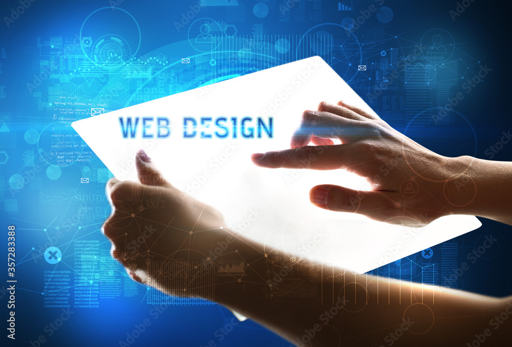 Hand holdig futuristic tablet with WEB DESIGN inscription, new technology concept Hand holdig futuristic tablet with WEB DESIGN inscription, new technology concept