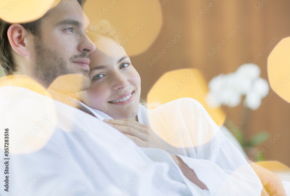Couple hugging in bathrobes