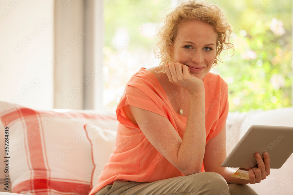 Portrait of woman using digital tablet on sofa Portrait of woman using digital tablet on sofa