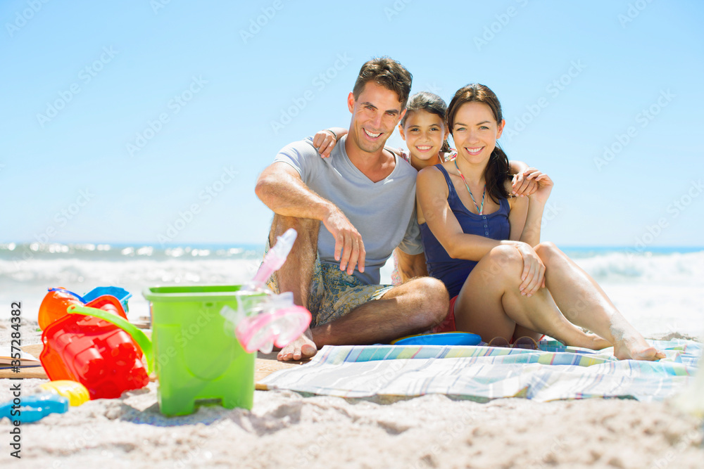 Portrait of smiling family sitting on beach