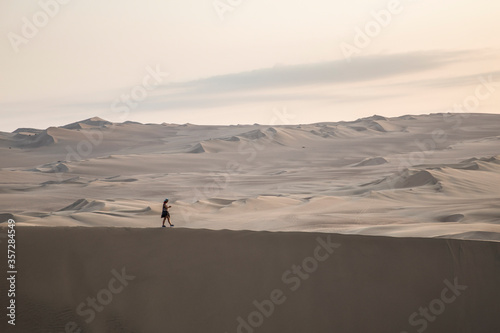 woman walking in the middle of the desert