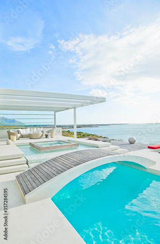 Wooden footbridge over luxury swimming pool © Dan Dalton/KOTO