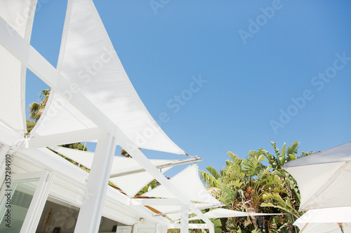 White awnings against blue sky photo