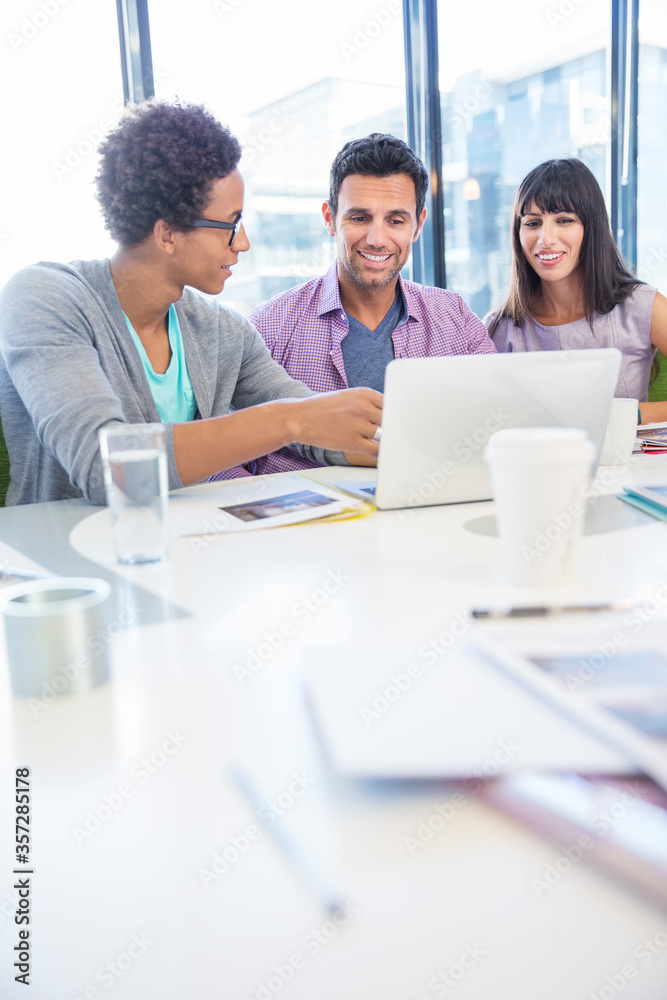 Business people sharing laptop in meeting Business people sharing laptop in meeting
