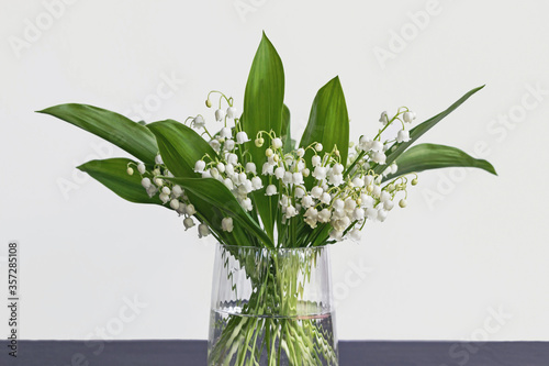 lily of the valley flower bouquet in glass vase with white background 