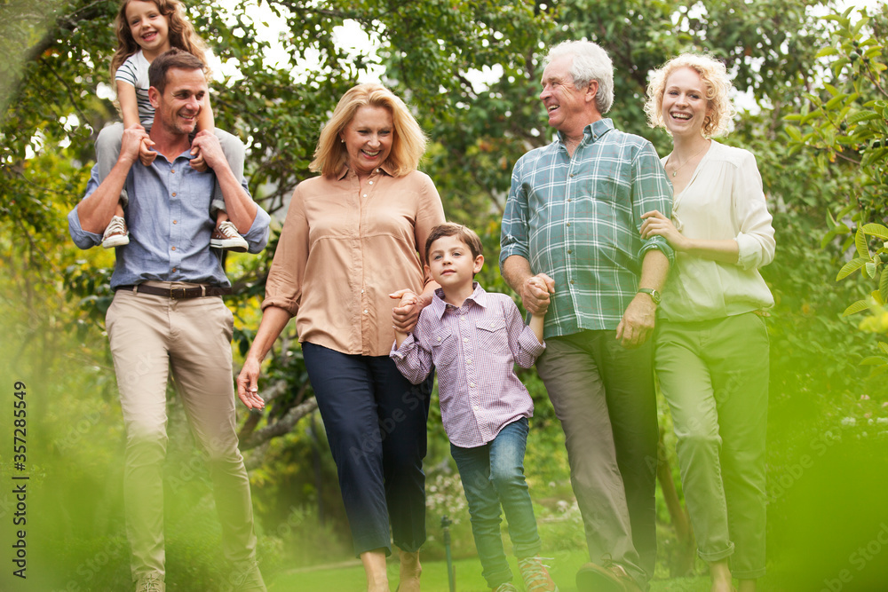 Multi-generation family walking in park