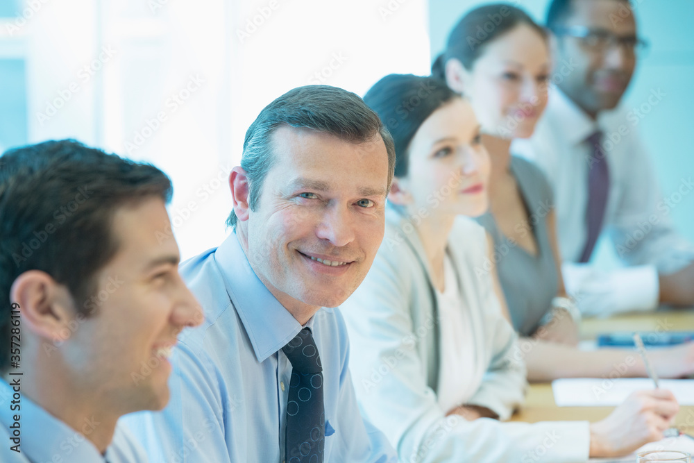 Businessman smiling in meeting Businessman smiling in meeting