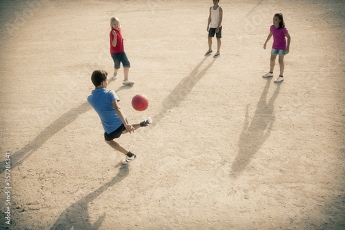 Wallpaper Mural Children playing with soccer ball in sand Torontodigital.ca