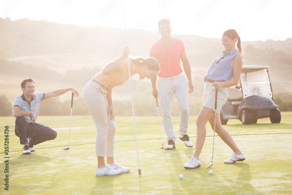 Friends laughing on golf course