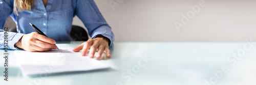 Businesswoman's Hand Signing Contract