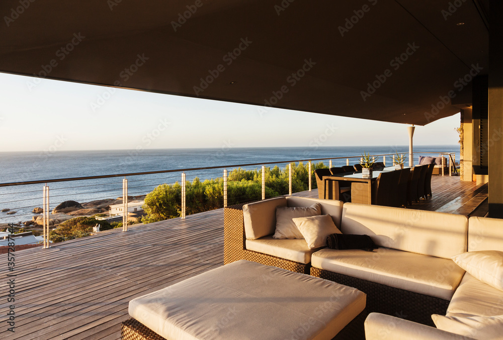 Obraz premium Sofa and table on luxury patio overlooking ocean