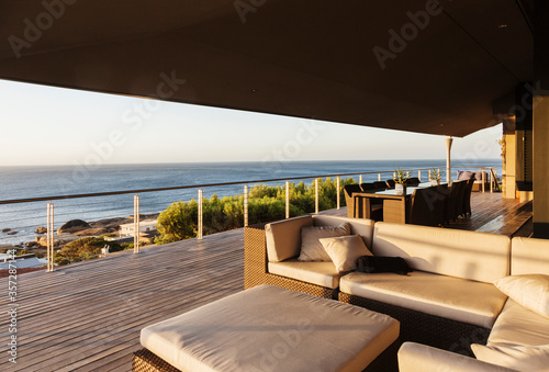 Sofa and table on luxury patio overlooking ocean