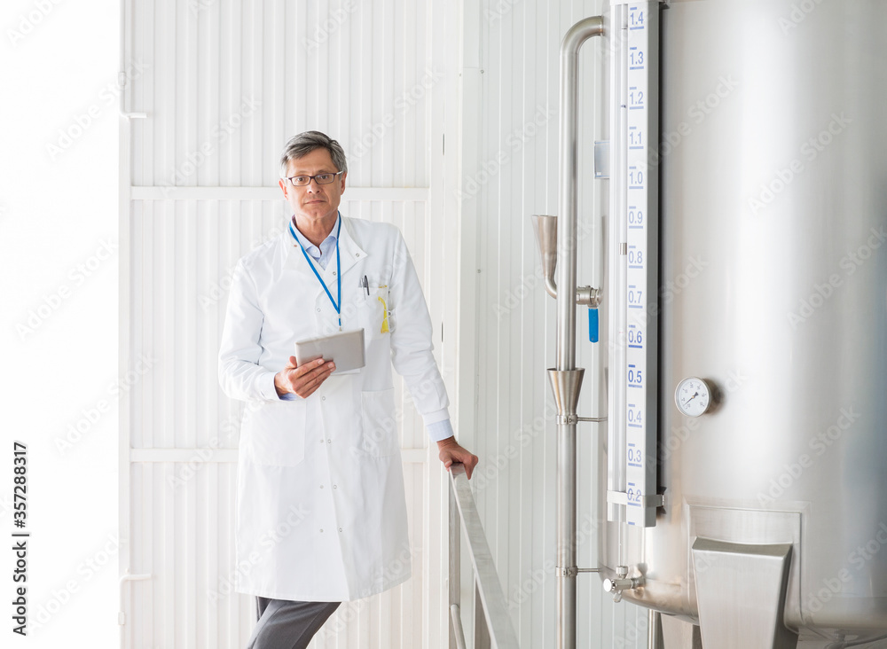 Scientist smiling in food processing plant Scientist smiling in food processing plant
