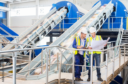 Fotografie Workers reading blueprints in recycling center