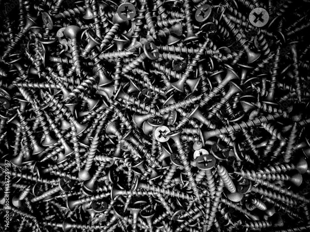 Mound of self-tapping screws, close-up of nails. Building material. Mound of self-tapping screws, close-up of nails. Building material.