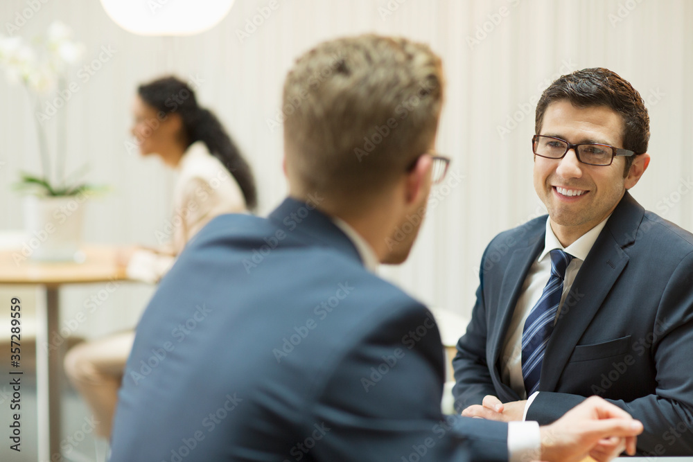 Businessmen talking in office