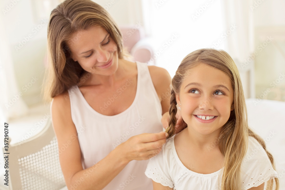 Mother braiding daughter's hair Mother braiding daughter's hair