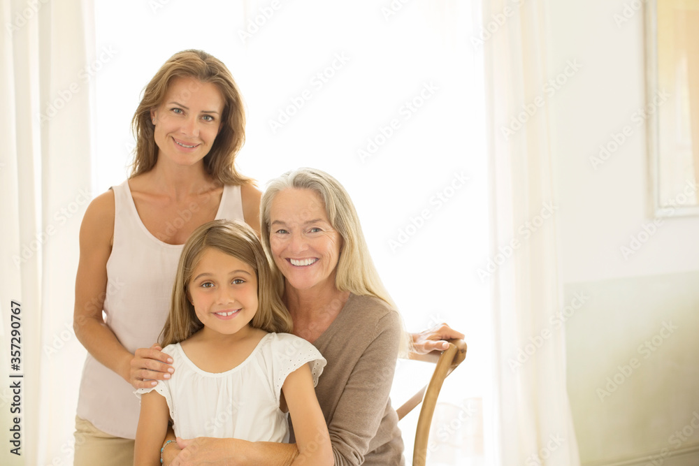 Multi-generation women smiling at window