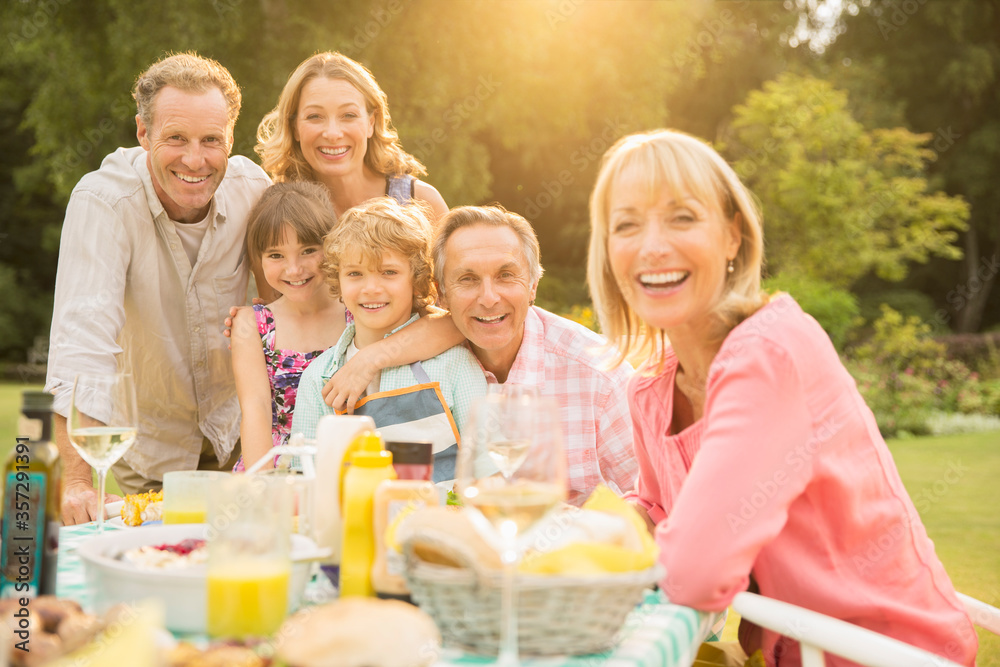 Multi-generation family at table in backyard