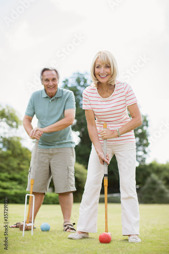 Couple playing croquet