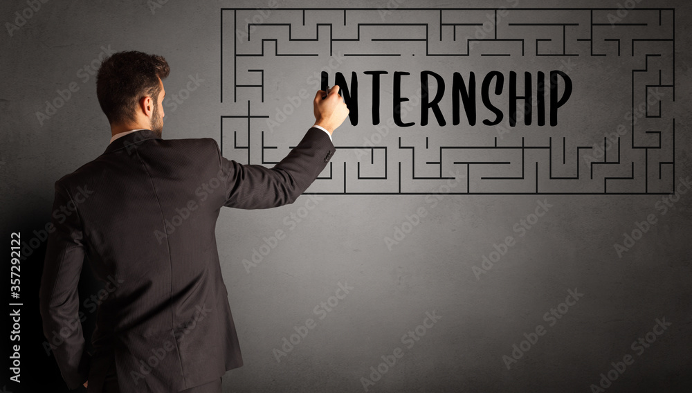 businessman drawing maze with INTERNSHIP inscription, business education concept businessman drawing maze with INTERNSHIP inscription, business education concept