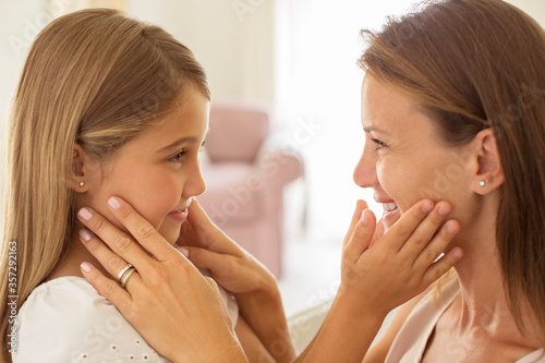 Mother and daughter touching faces