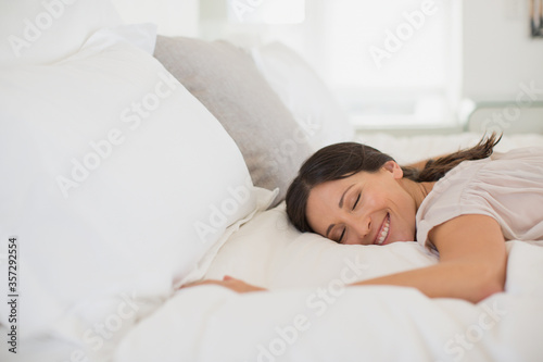 Smiling woman laying on bed