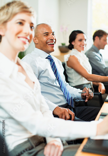 Foto Business people smiling in meeting