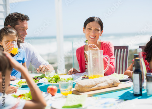 Family eating on patio with ocean in background