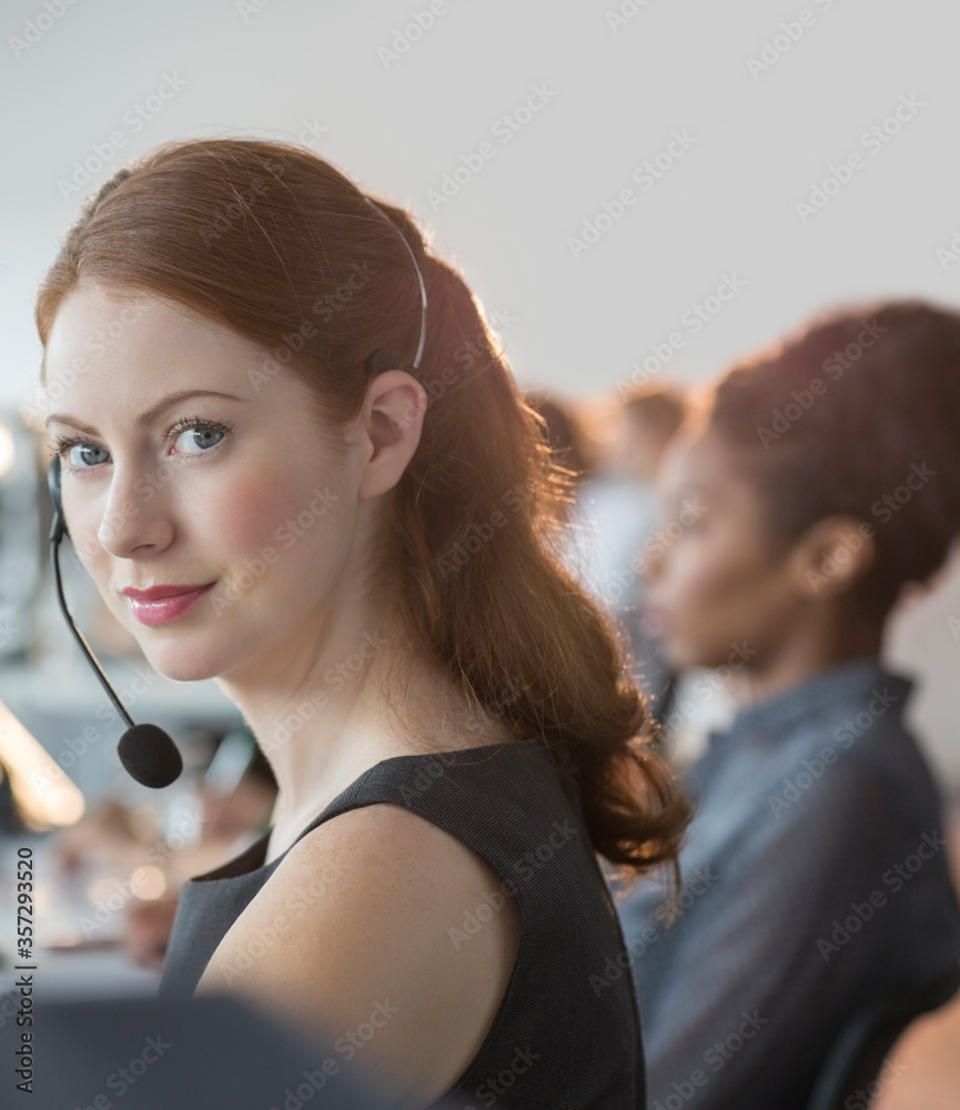 Businesswoman wearing headset in office Businesswoman wearing headset in office