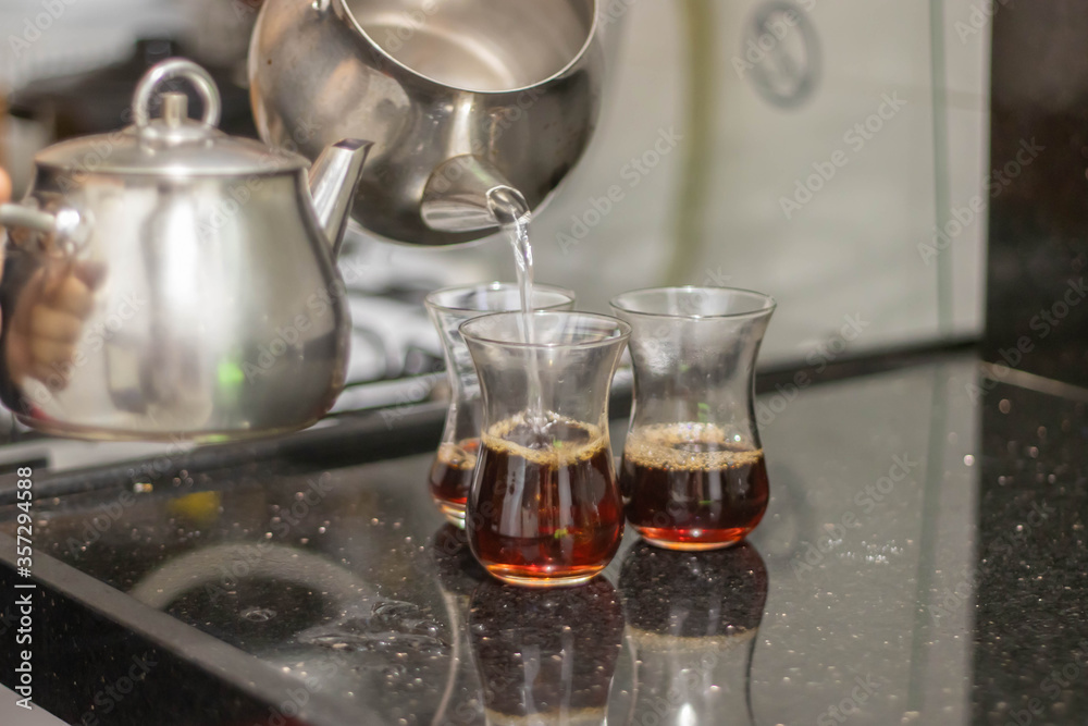 Turkish tea with authentic glass cup and silver tea kettle. Turkish tea with authentic glass cup and silver tea kettle.