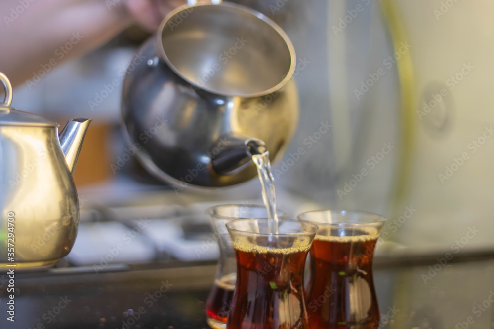 Turkish tea with authentic glass cup and silver tea kettle. Turkish tea with authentic glass cup and silver tea kettle.