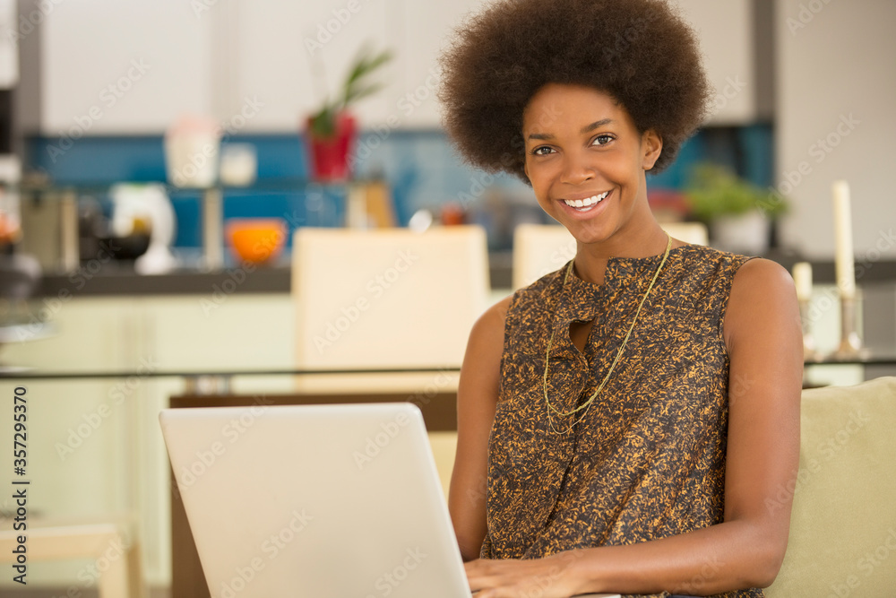 Businesswoman using laptop in kitchen Businesswoman using laptop in kitchen