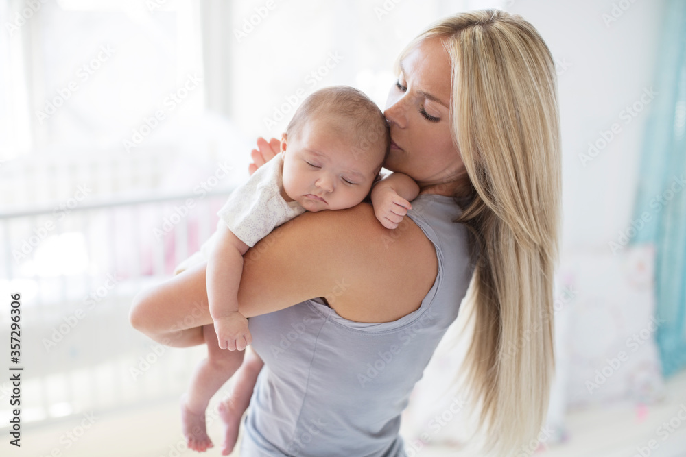 Mother carrying sleeping baby girl Mother carrying sleeping baby girl